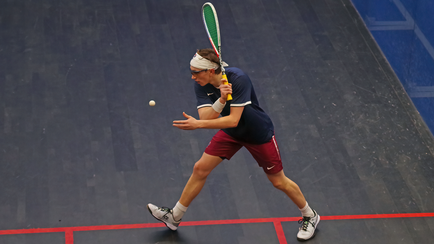 Andrew Douglas prepares to swing at the ball during a squash match.