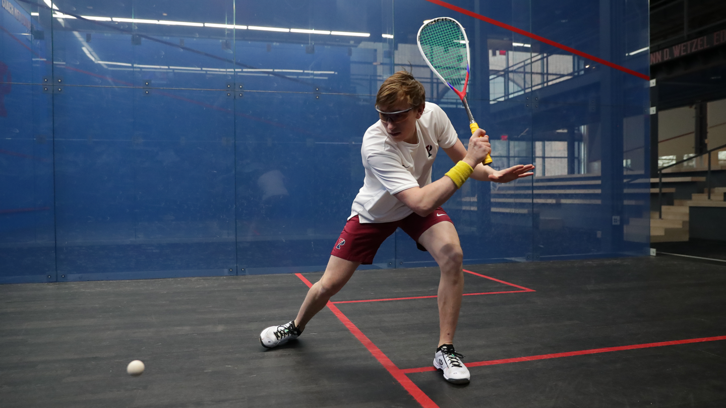Andrew Douglas prepares to swing at the ball during a squash match.