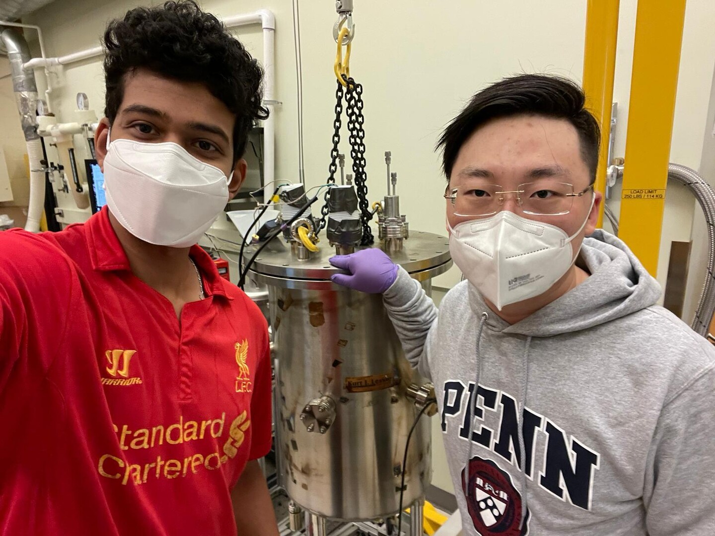 shivajee govind and yi jin standing in a lab wearing masks