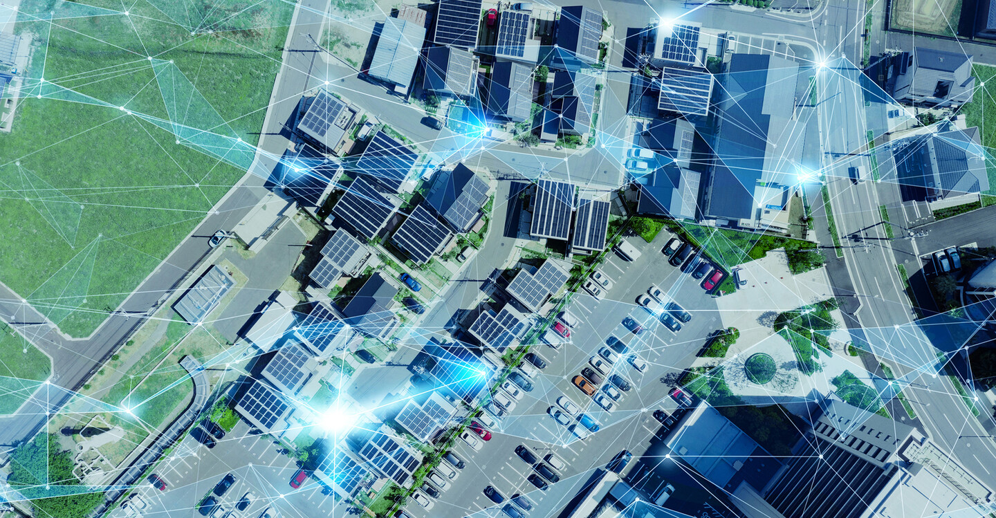 birds eye view of city with tops of buildings and parked cars