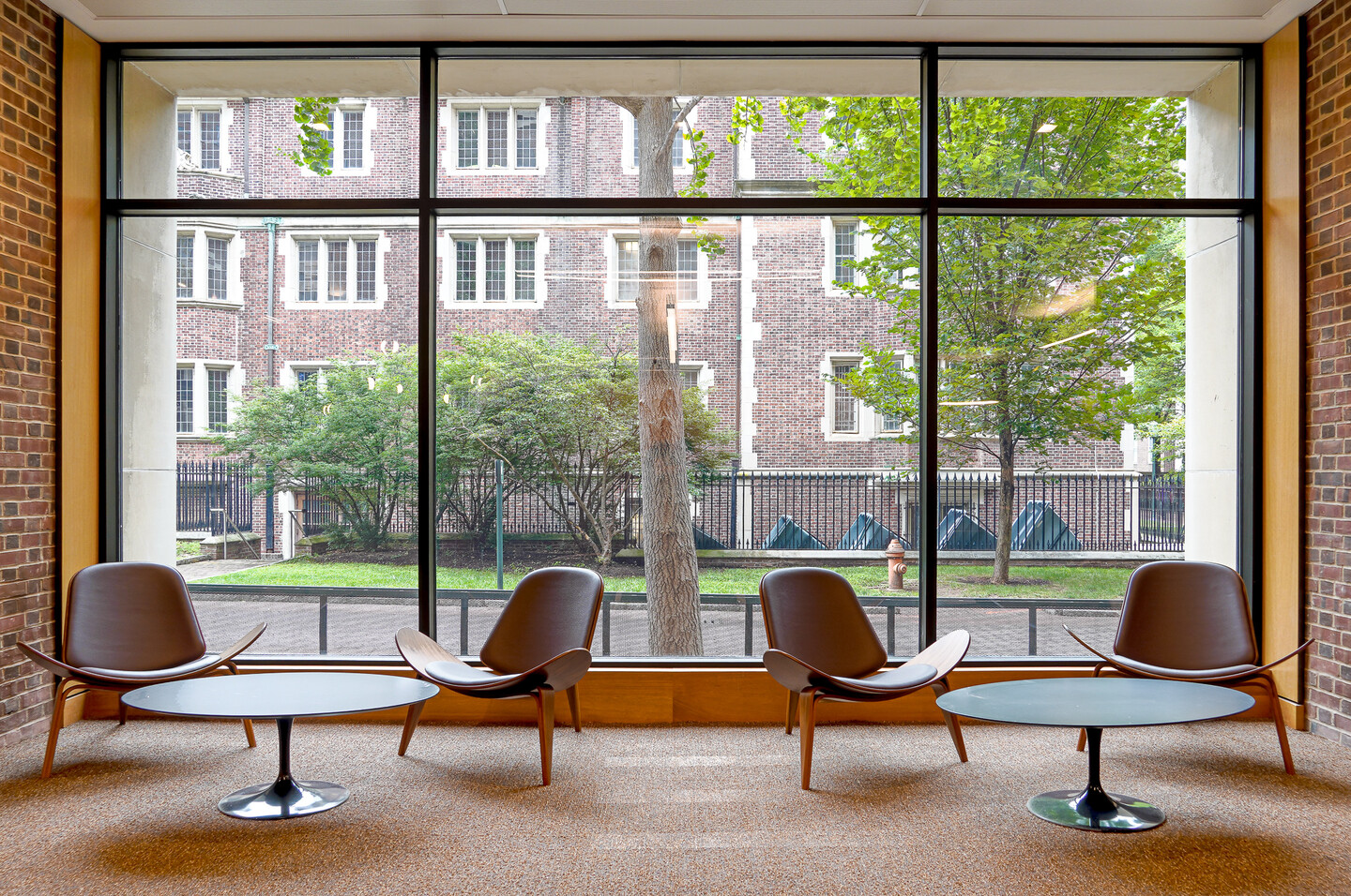 four chairs and two table sin front of a window