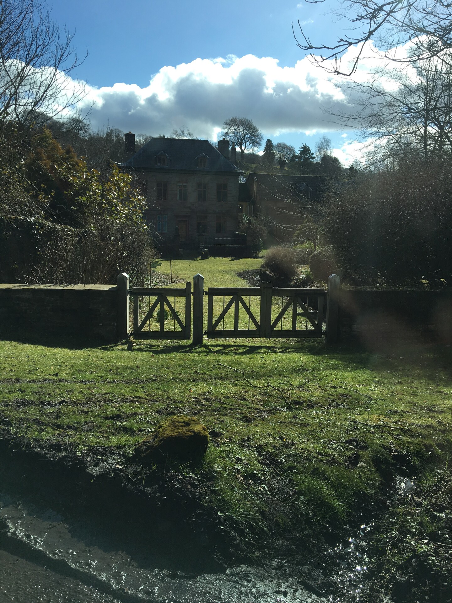 Manor house behind a gated fence