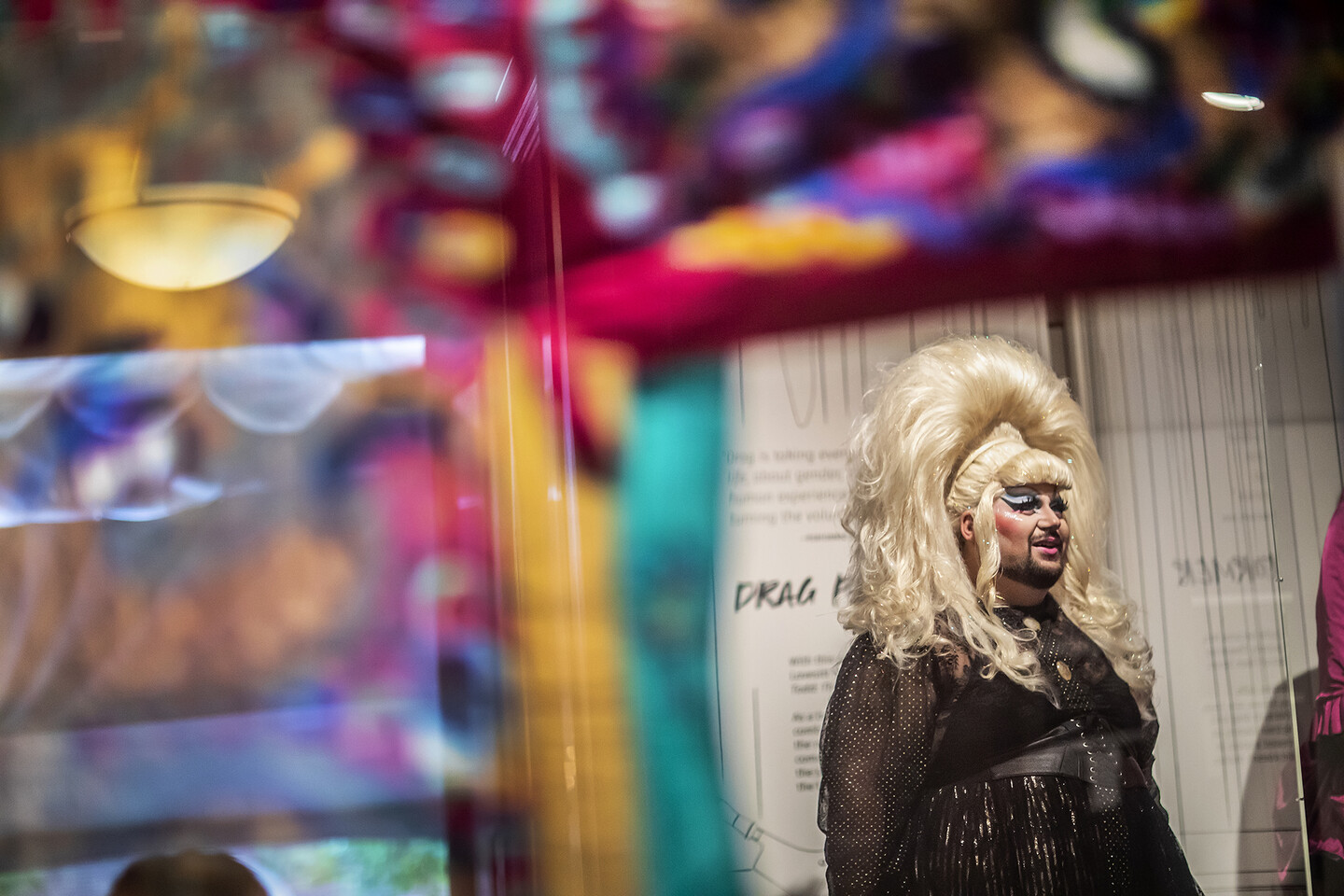 person with big wig standing in gallery