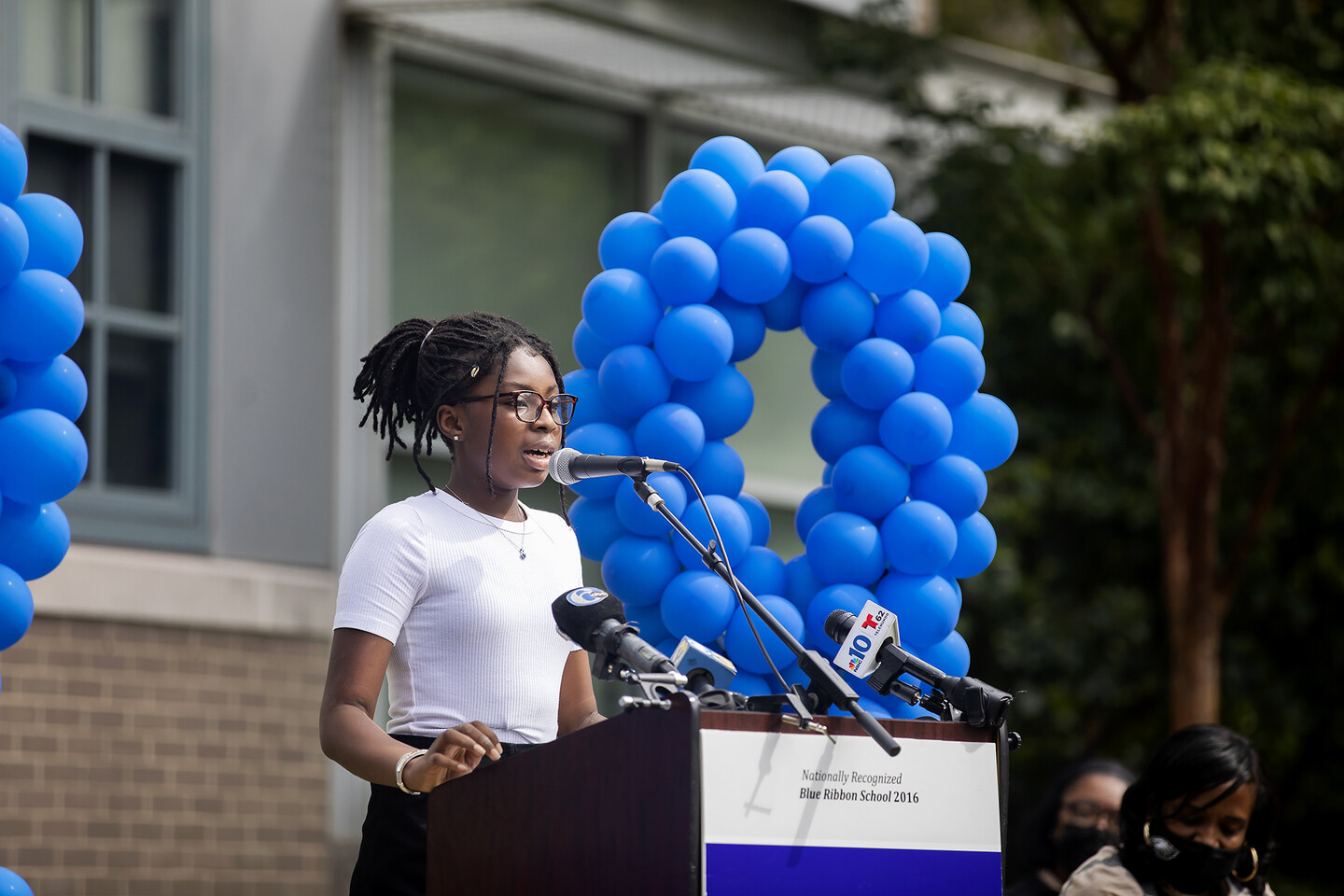 Student reads a poem at podium