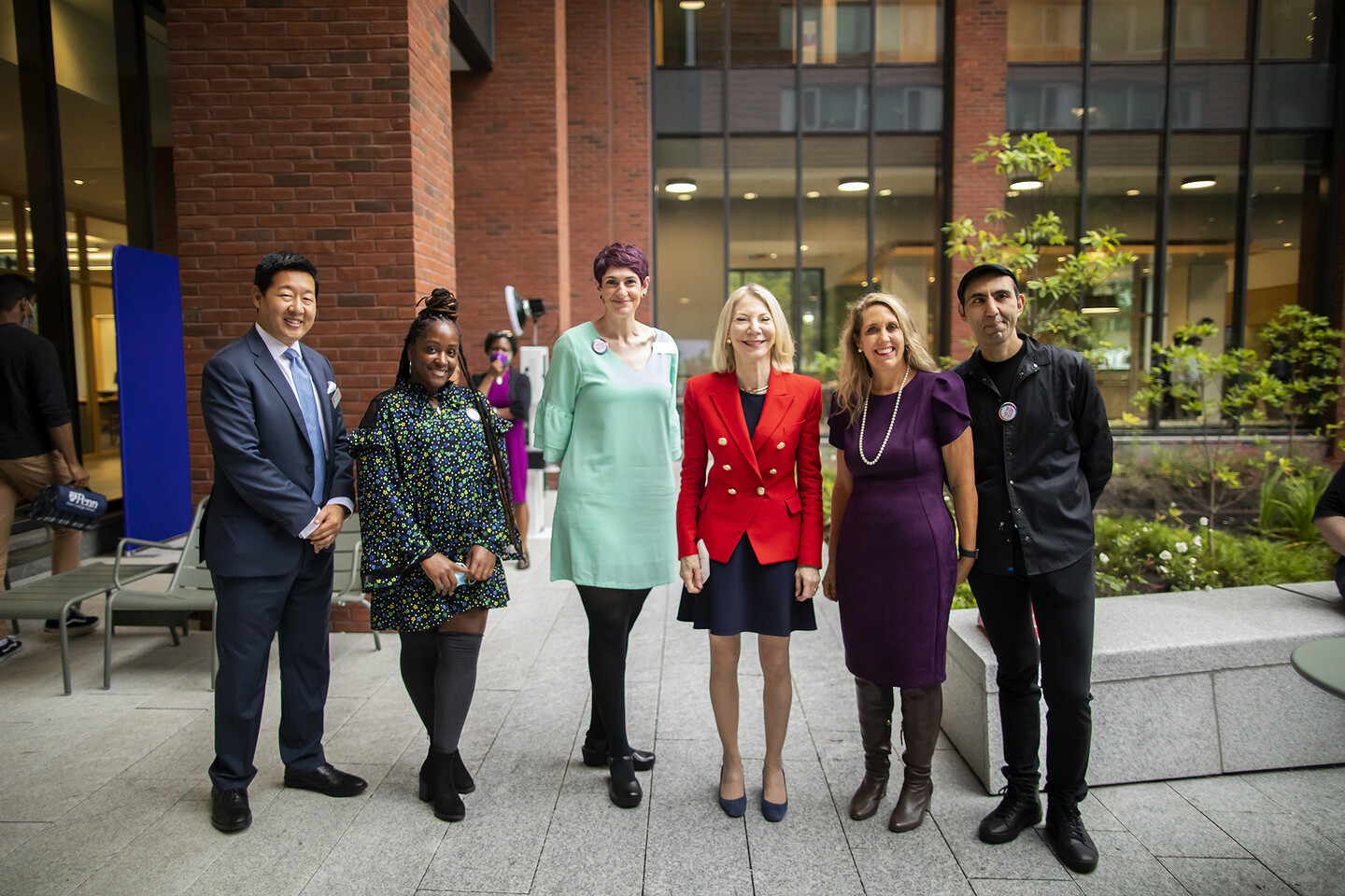 five people standing in residence hall courtyard