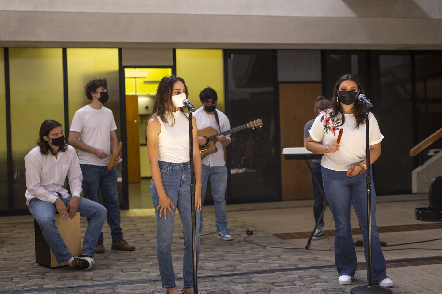 Six students sing and play musical instruments