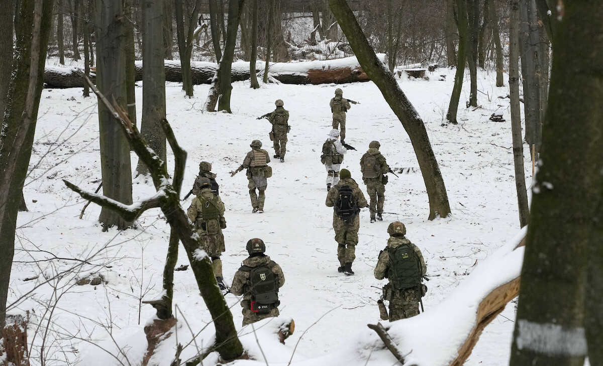 Members of Ukraine's Territorial Defense Forces, volunteer military units of the Armed Forces, train in a snow covered city park in Kyiv.