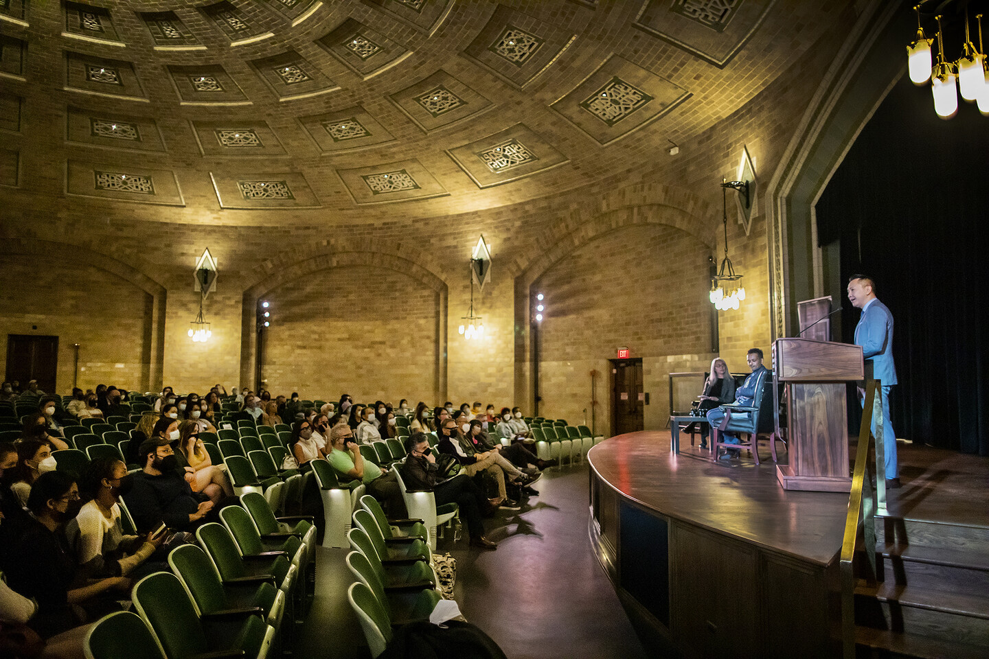 Viet Thanh Nguyen speaks at podium and crowd looks on