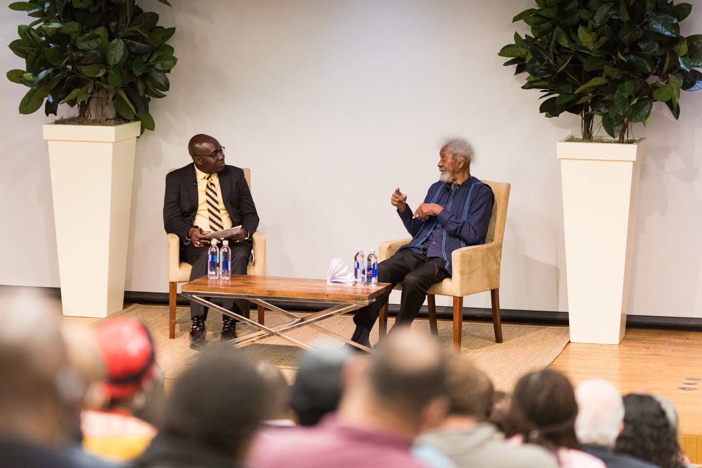 two people speaking on stage 