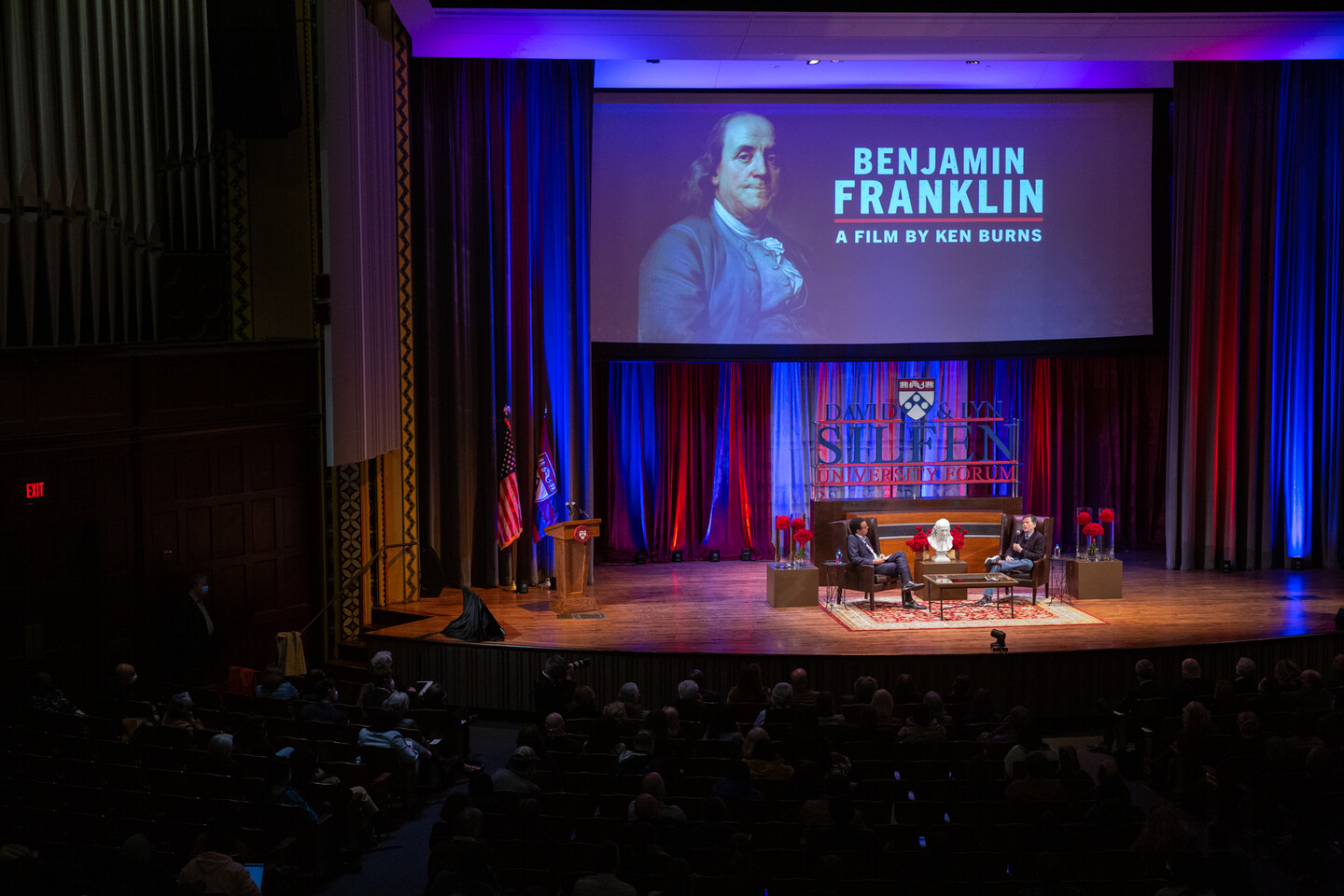Wendell Pritchett seated on stage with Ken Burns.
