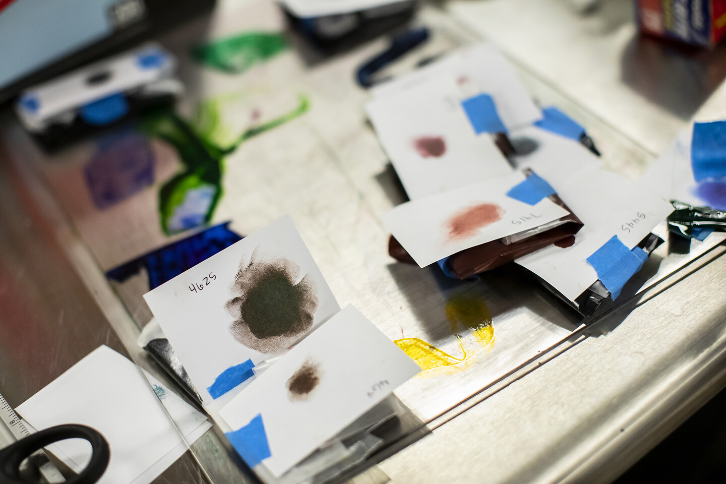 smudges of color on small cards on a table