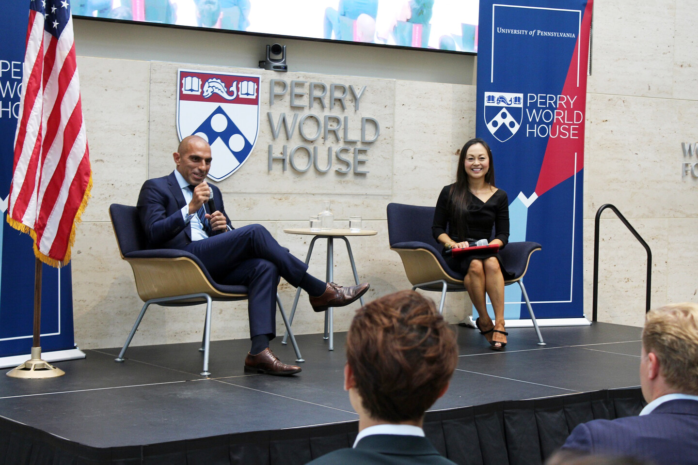Rostin Behnam and Sarah Hammer sitting on stage.