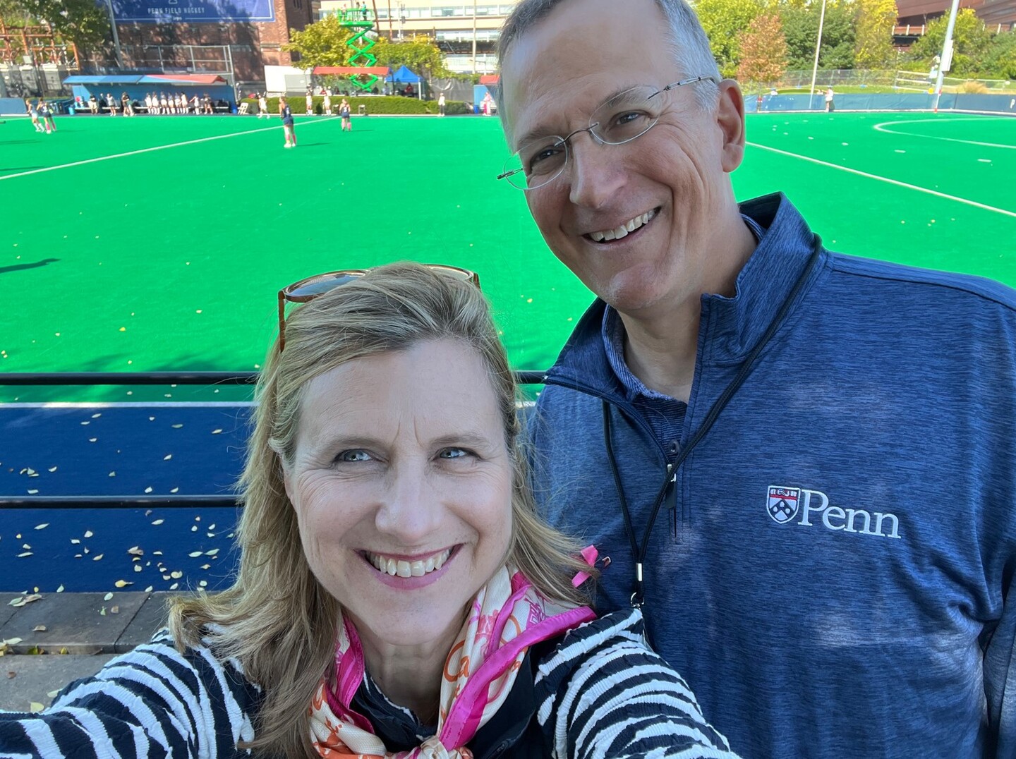 President Liz Magill enjoys the game with her husband Leon Szeptycki.