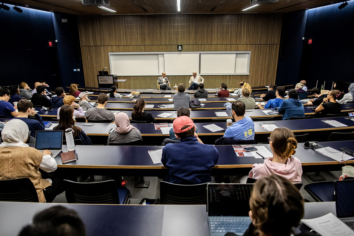 Penn students and faculty sit in an auditorium listening to Tor Wennesland speak