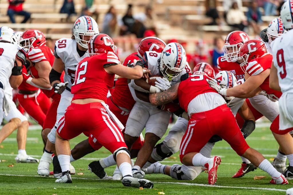 Running back Trey Flowers runs through tacklers during the game.