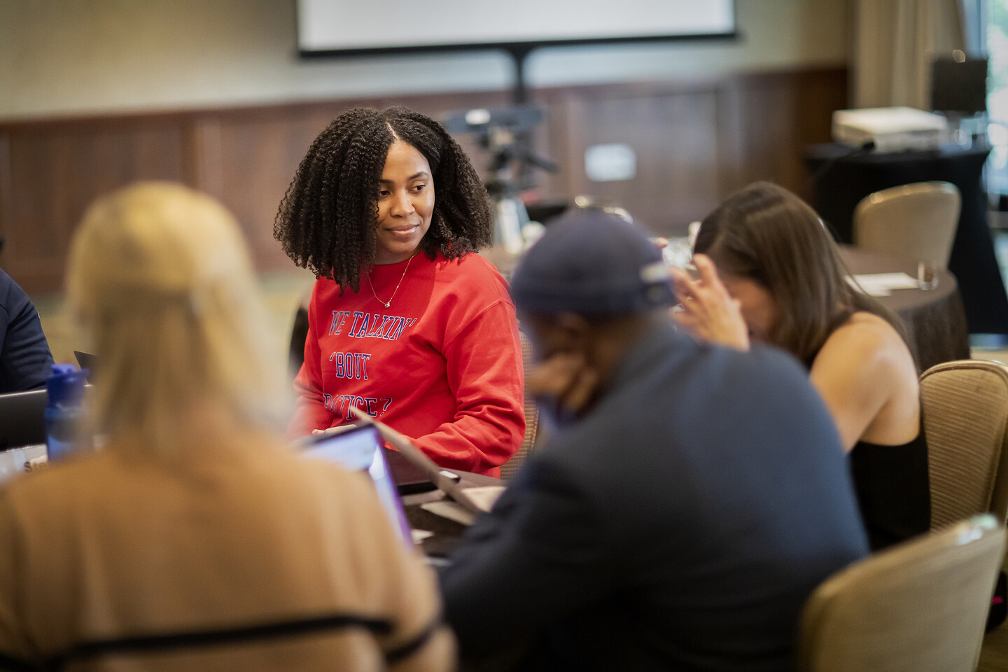Dennice Anderson sitting at table with other students