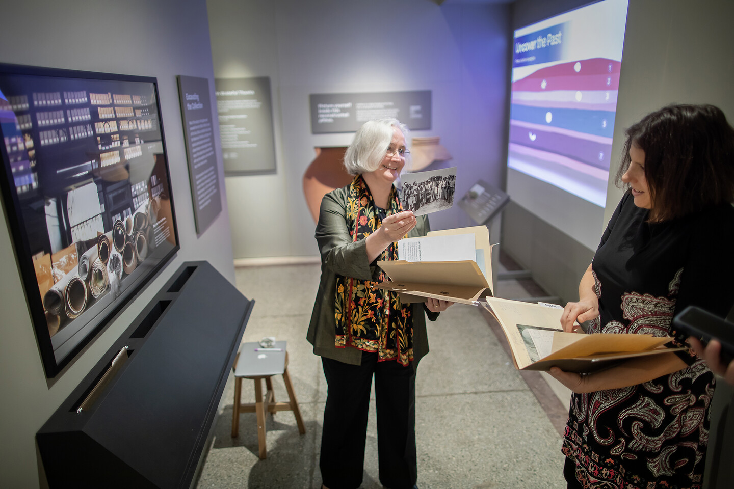 Joanna Smith and Lauren Ristvet go through documents in folders