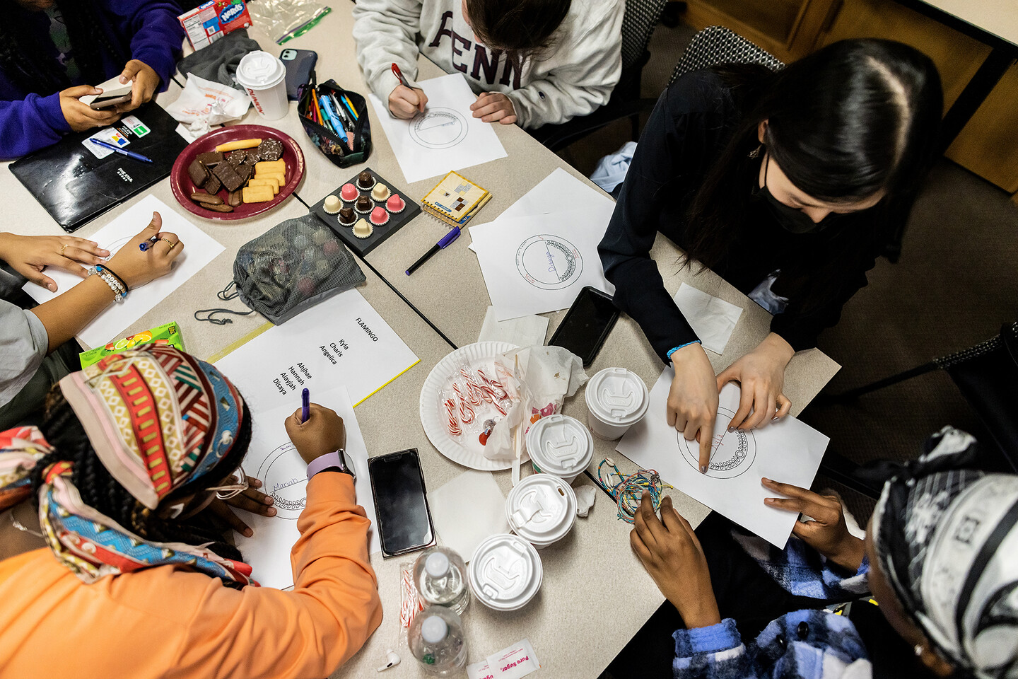 Students from Robeson High School write out compliment cards to their classmates. 