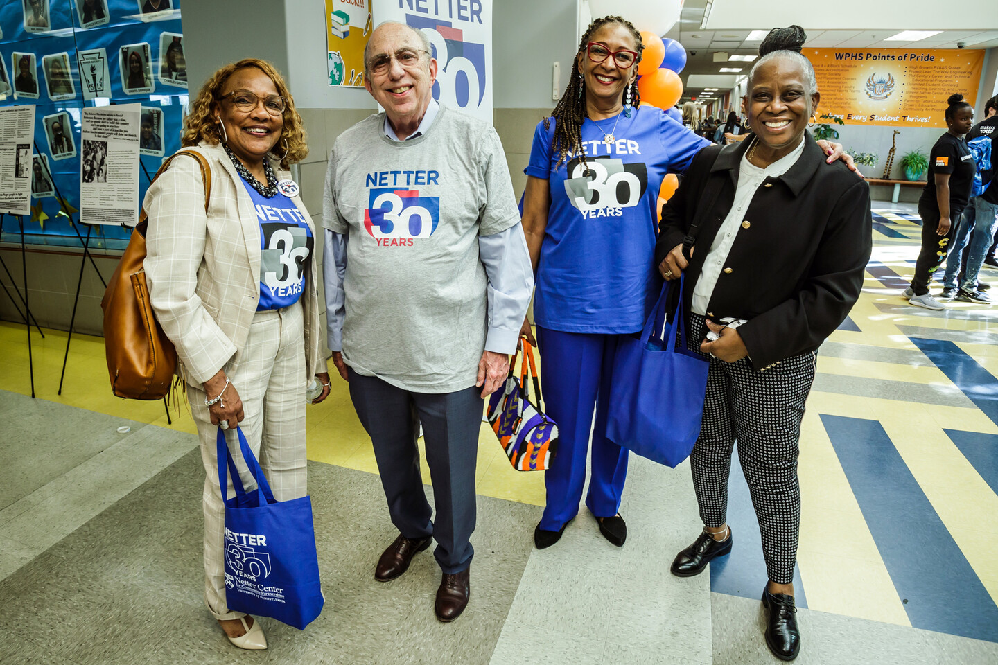 Netter Center staff and advisory board members pose on the gallery walk with anniversary t-shirts that read: Netter 30 years