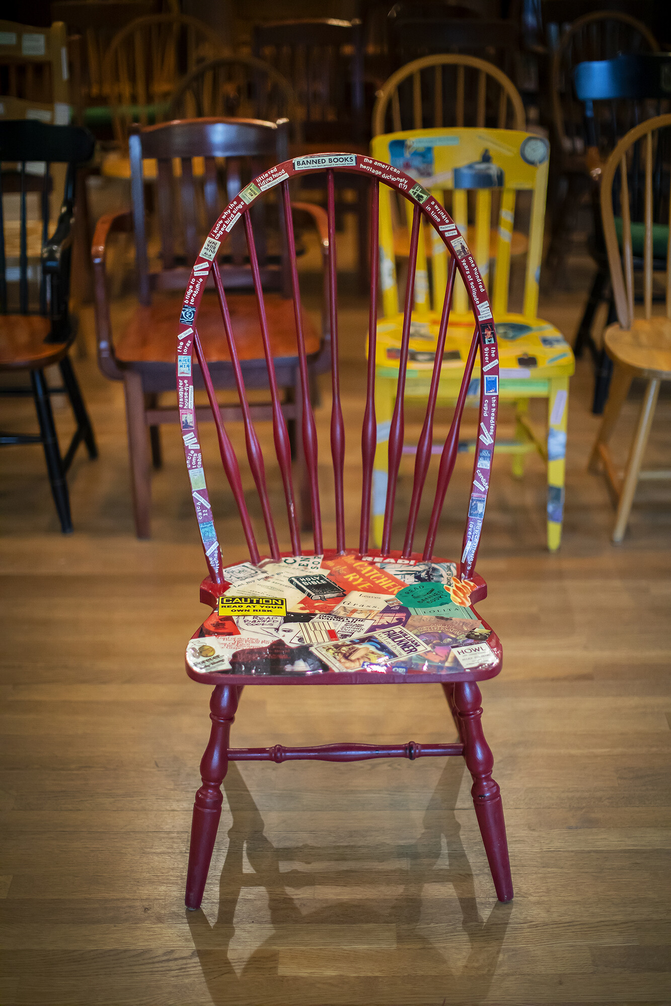 Banned Books Chair, covered in stickers of banned book covers.