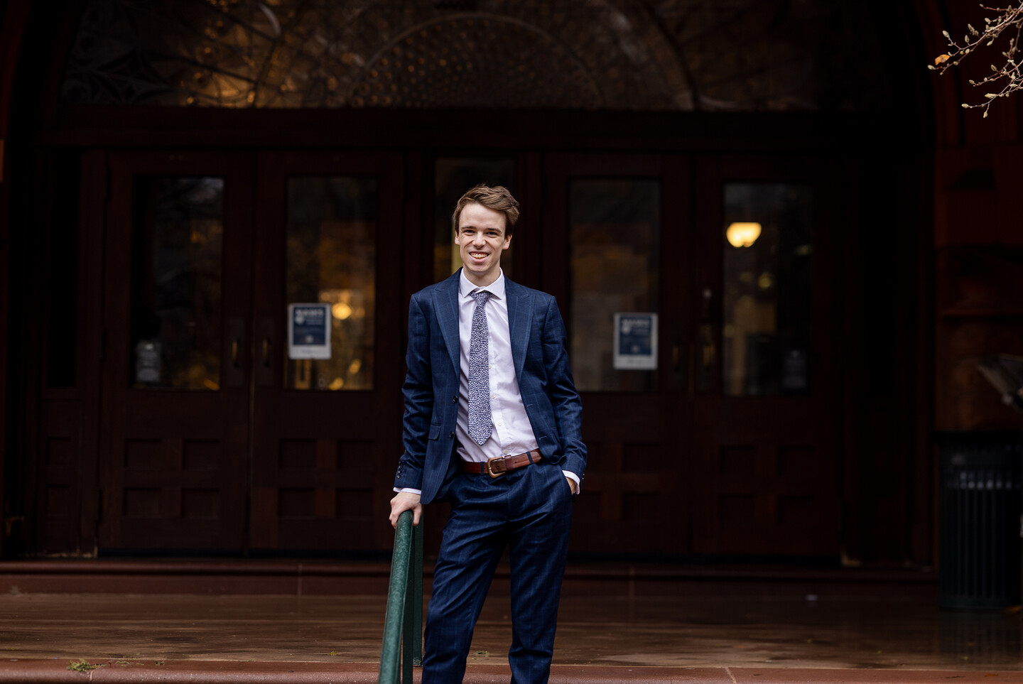 Thomas Sharrock standing on the steps outside a building 