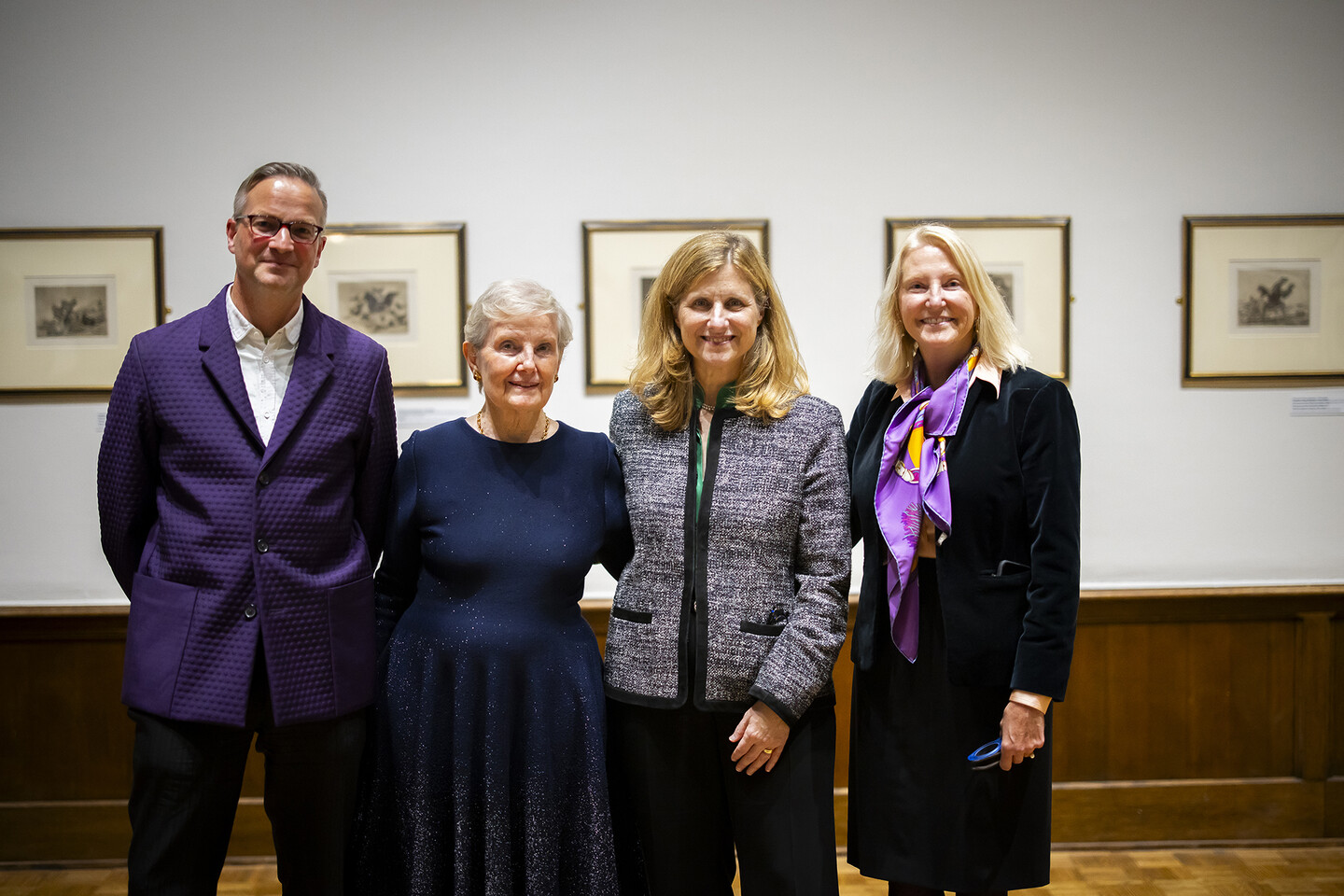 Four people standing in an art gallery. 