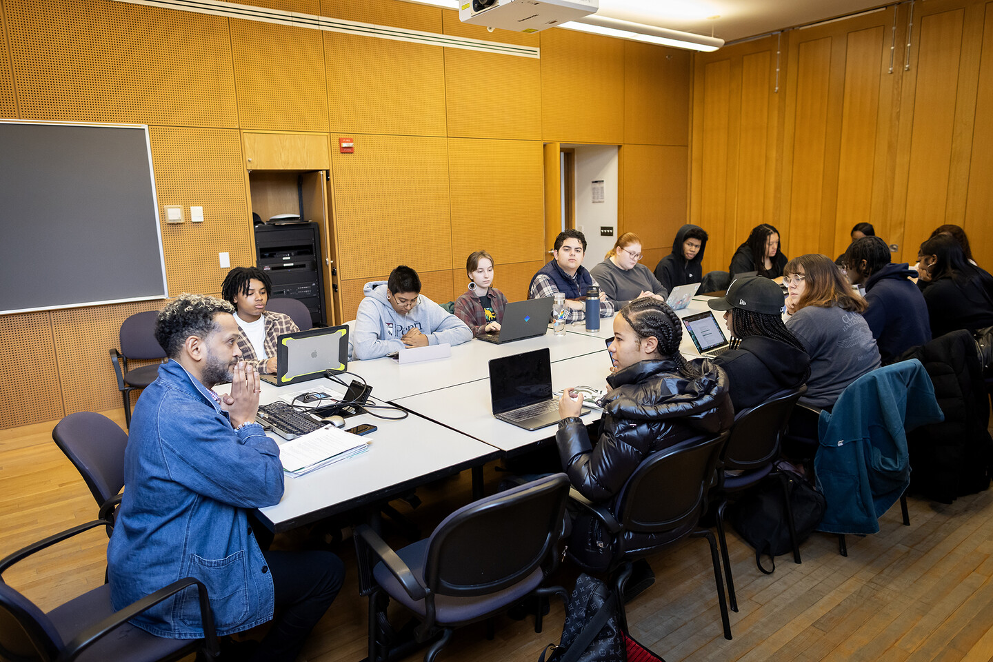 Students and Professor Woubshet gathered around a classroom seminar table.