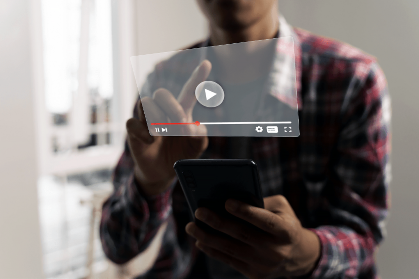 A person pressing play on a YouTube video on a smartphone.