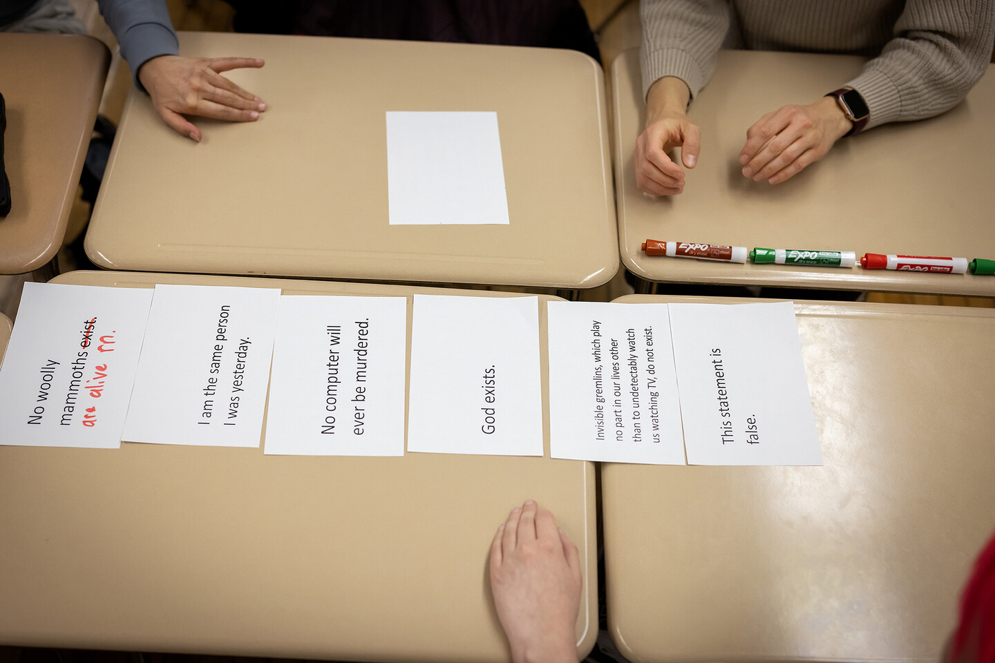 Statements laid out on table for Philosophy Club activity.