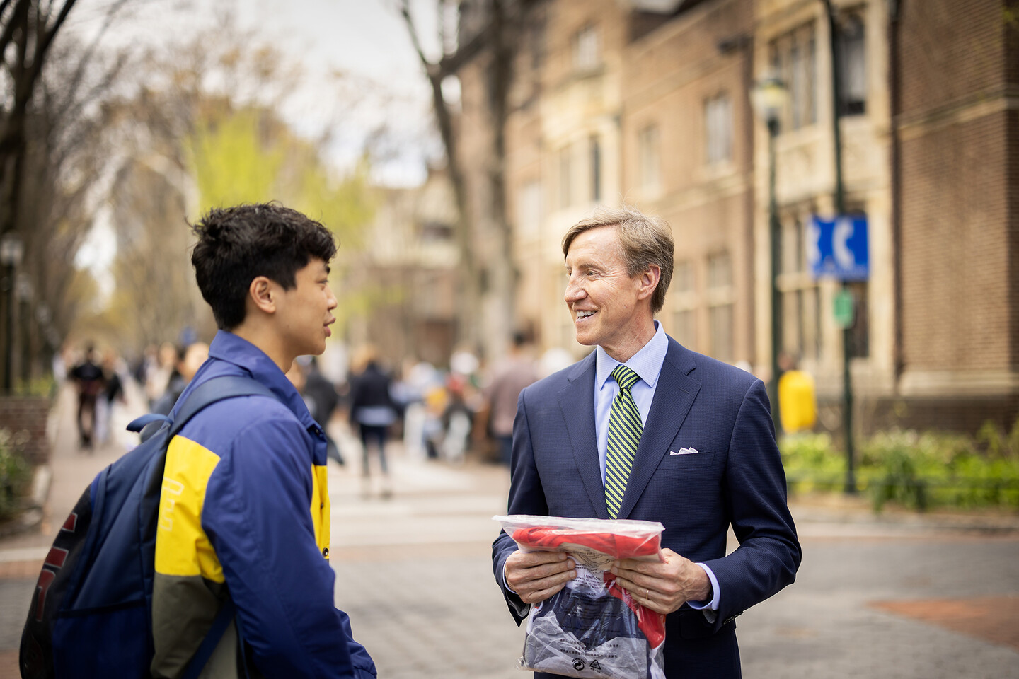 Bryce Louie of the fencing team chats with Interim President Larry Jameson.