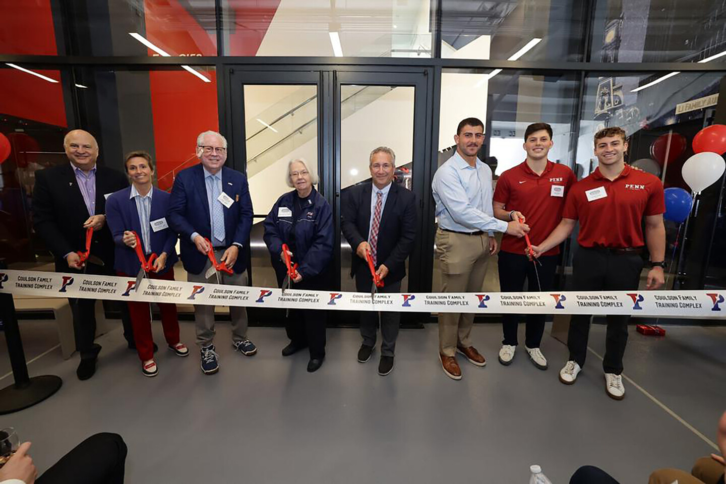 Penn coaches and administrators cut the ribbon for the Coulson Family Training Complex.