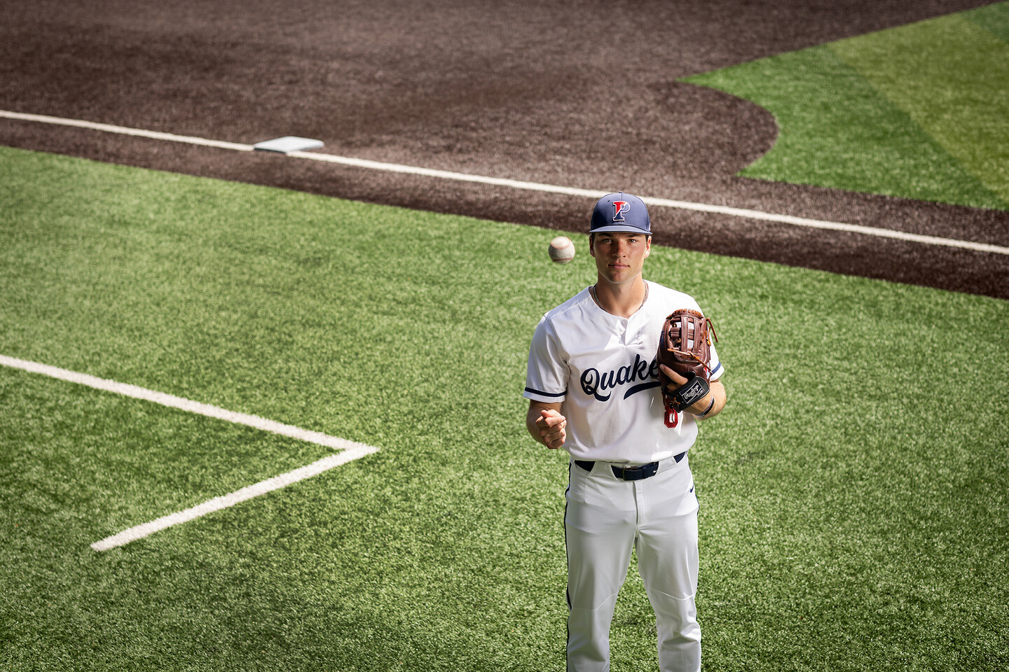 Wyatt Henseler tosses a ball in the air while on the field at Meiklejohn Stadium
