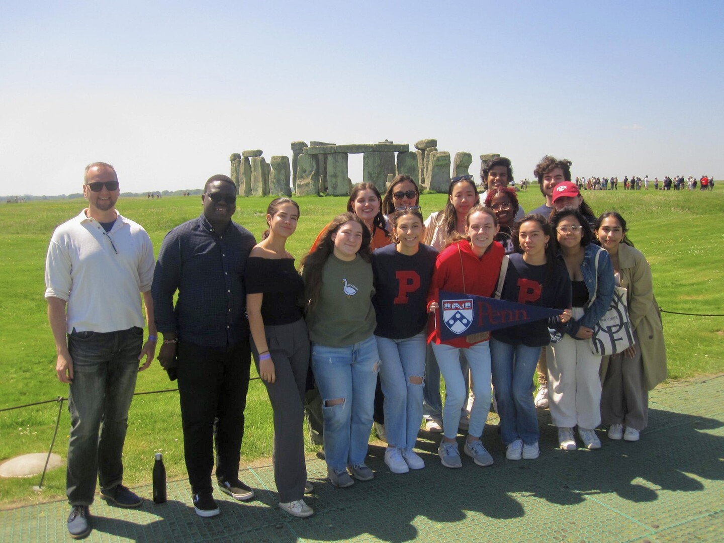 A group photo of the class with Stonehenge in the background