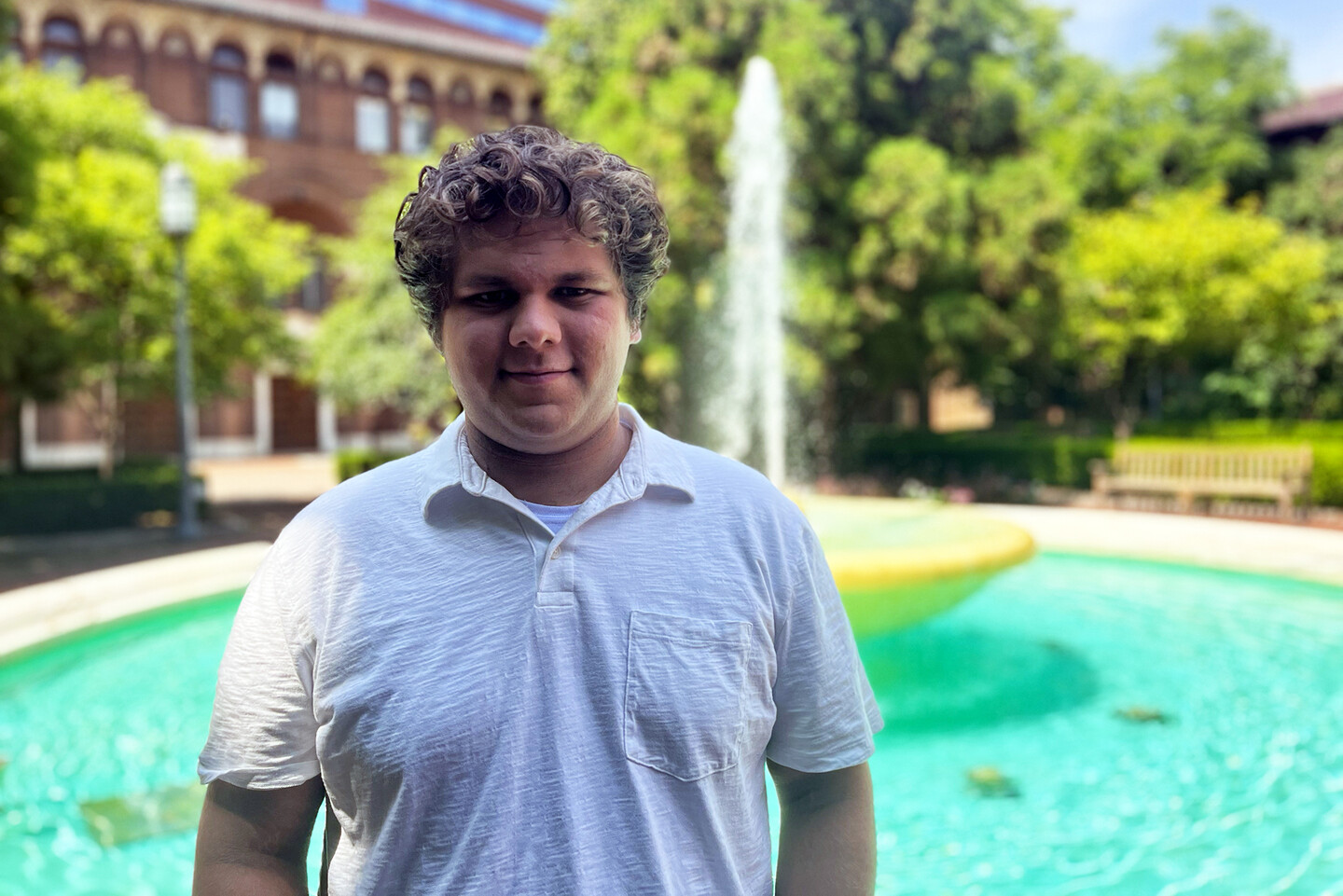 Ethan Nemeth standing in front of fountain