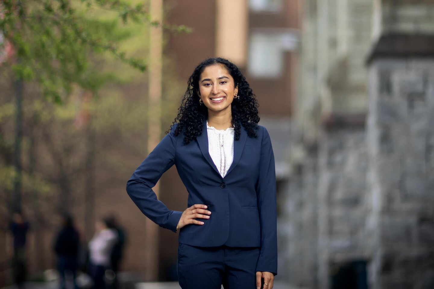 Rashmi Acharya standing outside with hand on hip