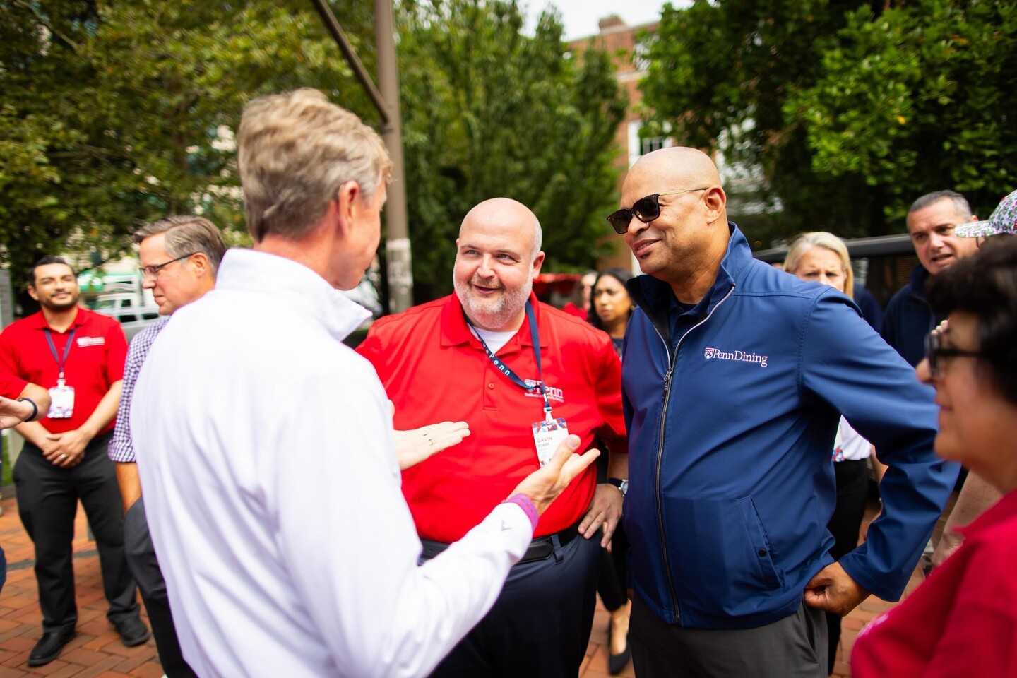 Michael Scales and another Penn staff member speaking with J. Larry Jameson outside on Penn’s campus.