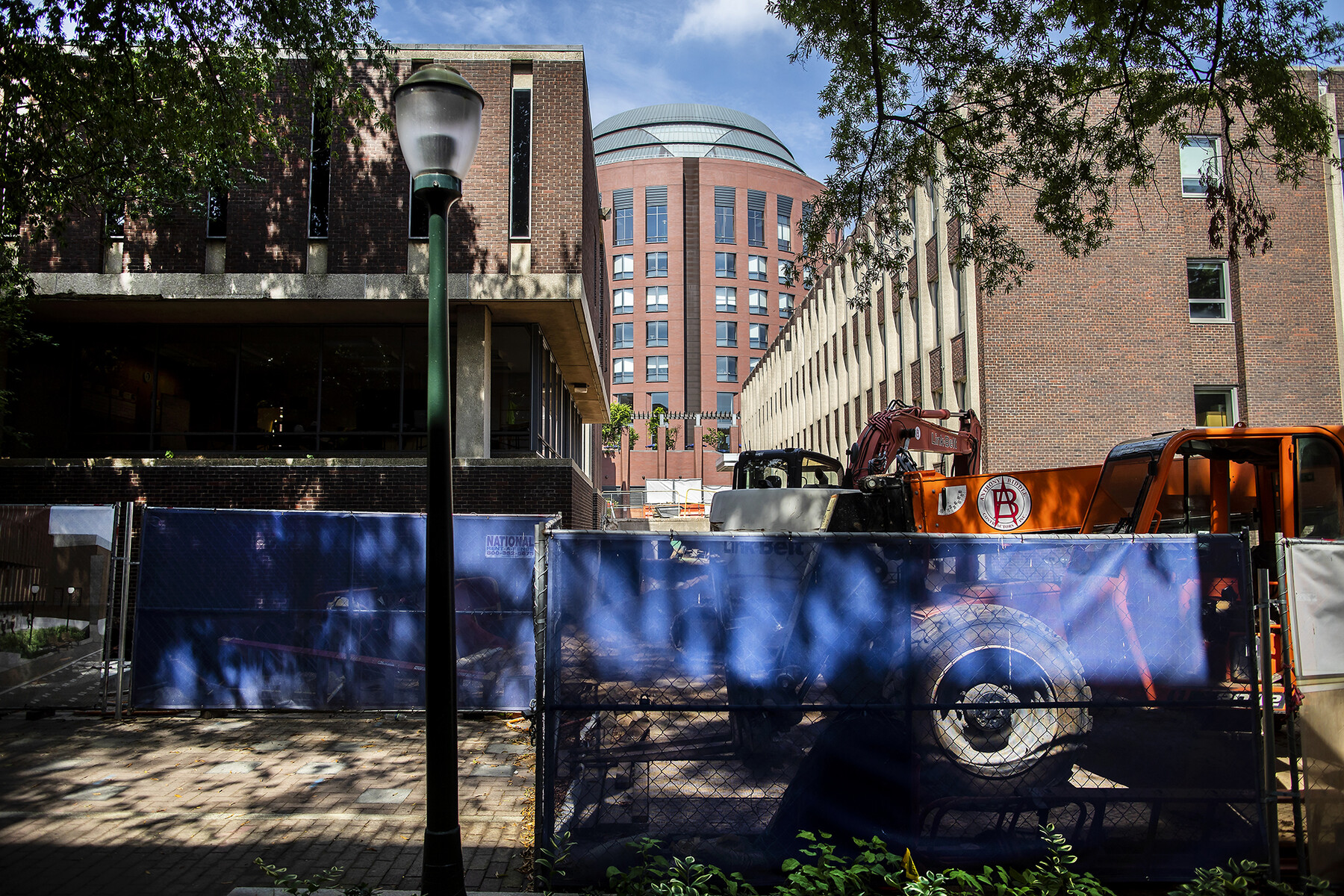 Sidewalk closed off due to construction with Huntsman Hall in background.