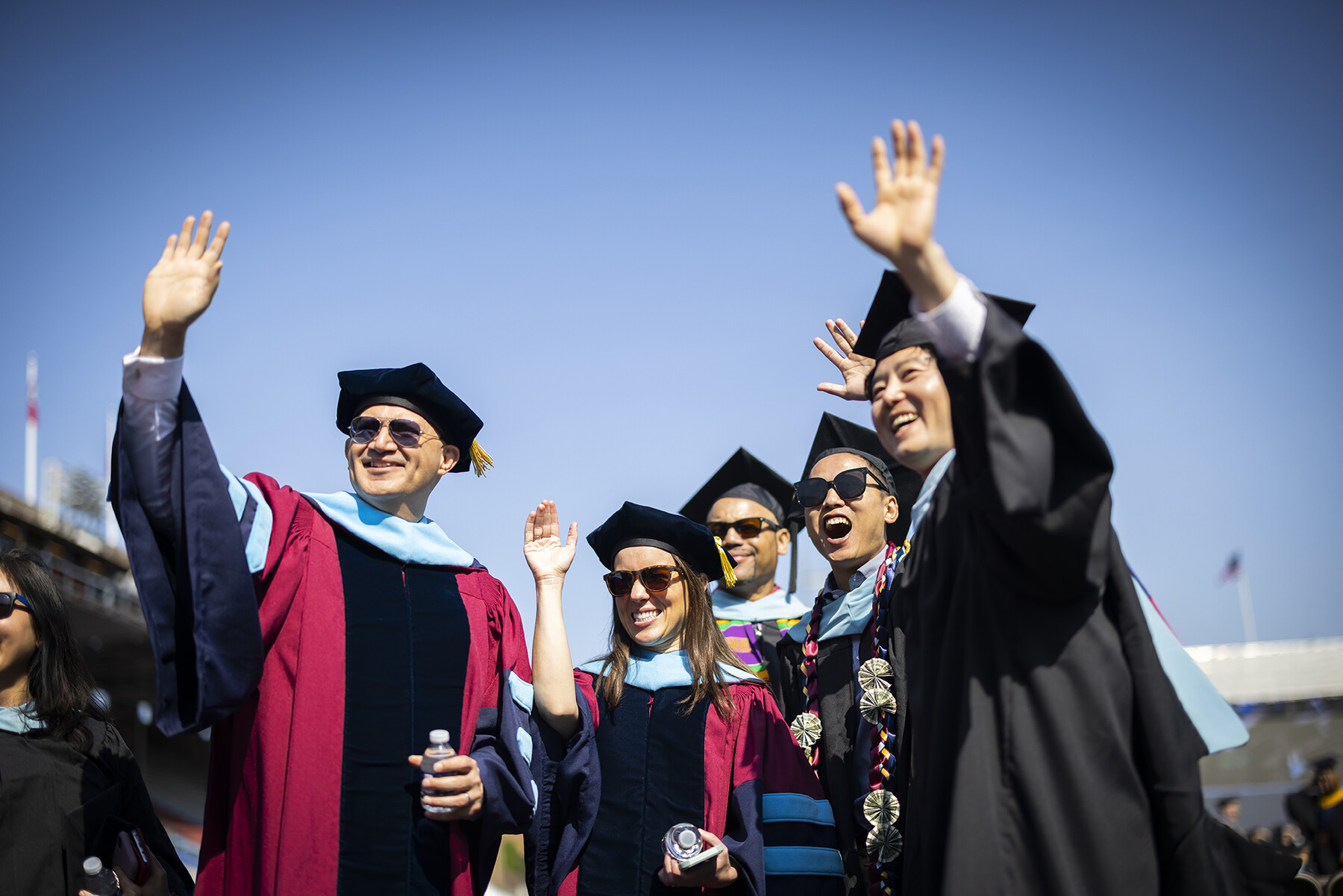students wave to family during commencement
