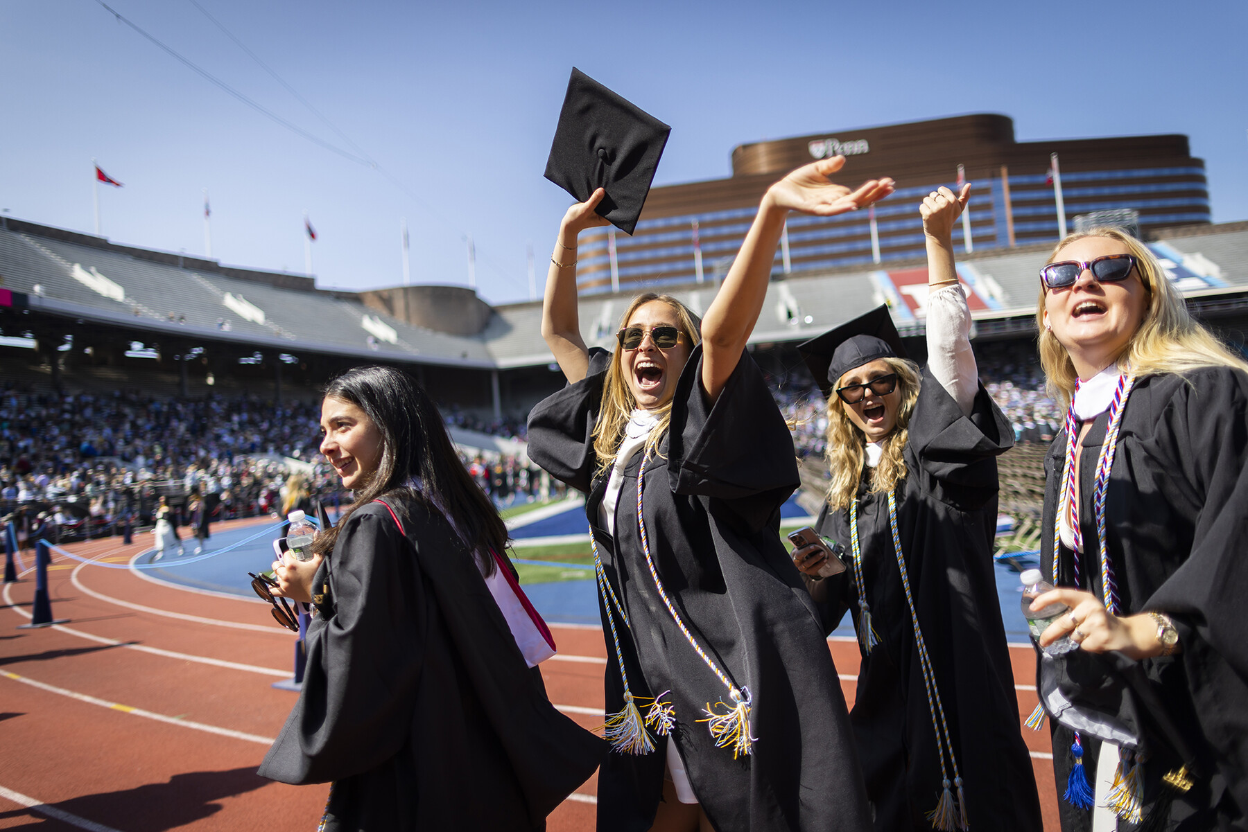 students waving as they enter franklin field