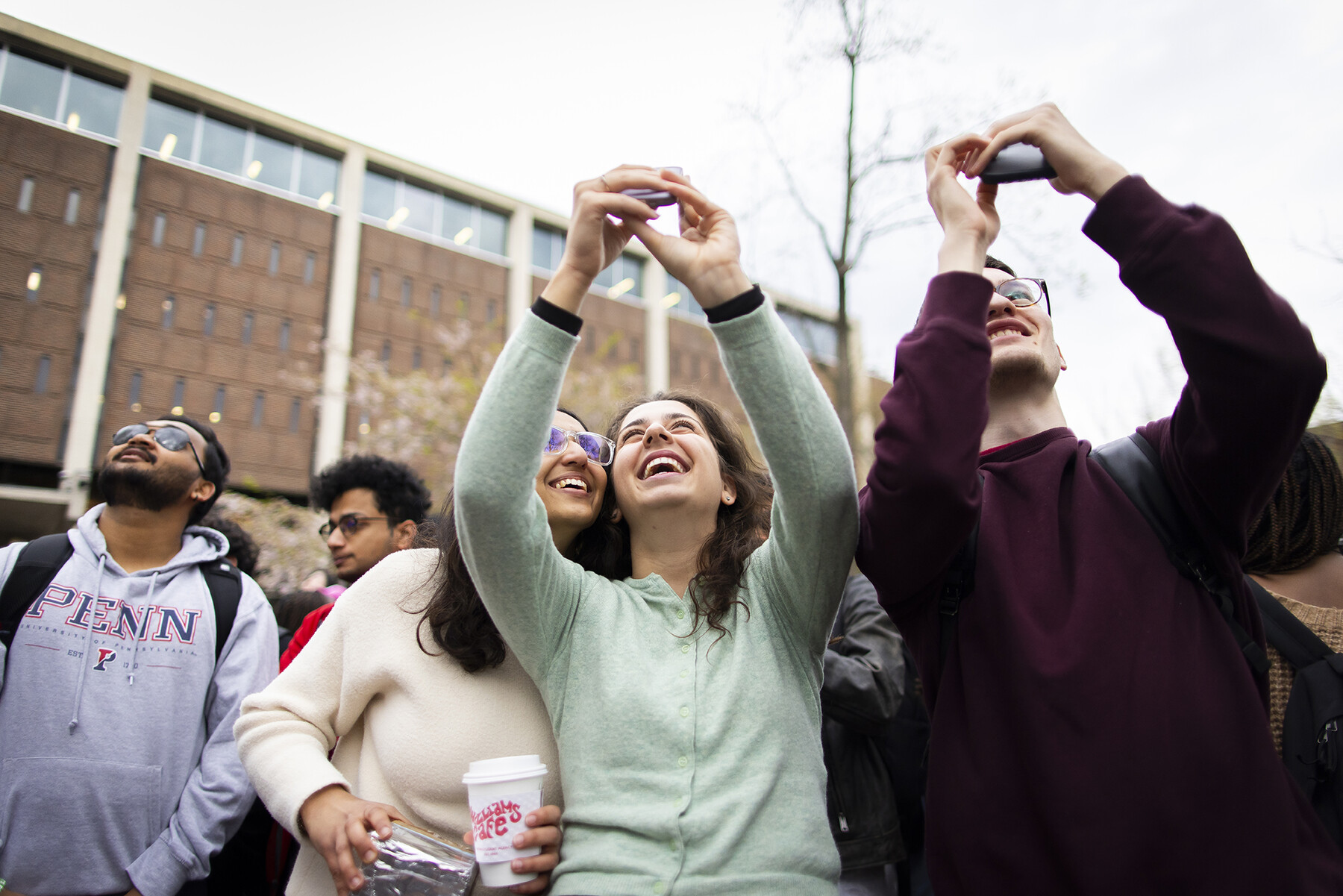 People take selfies during the solar eclipse on Penn’s college Green.