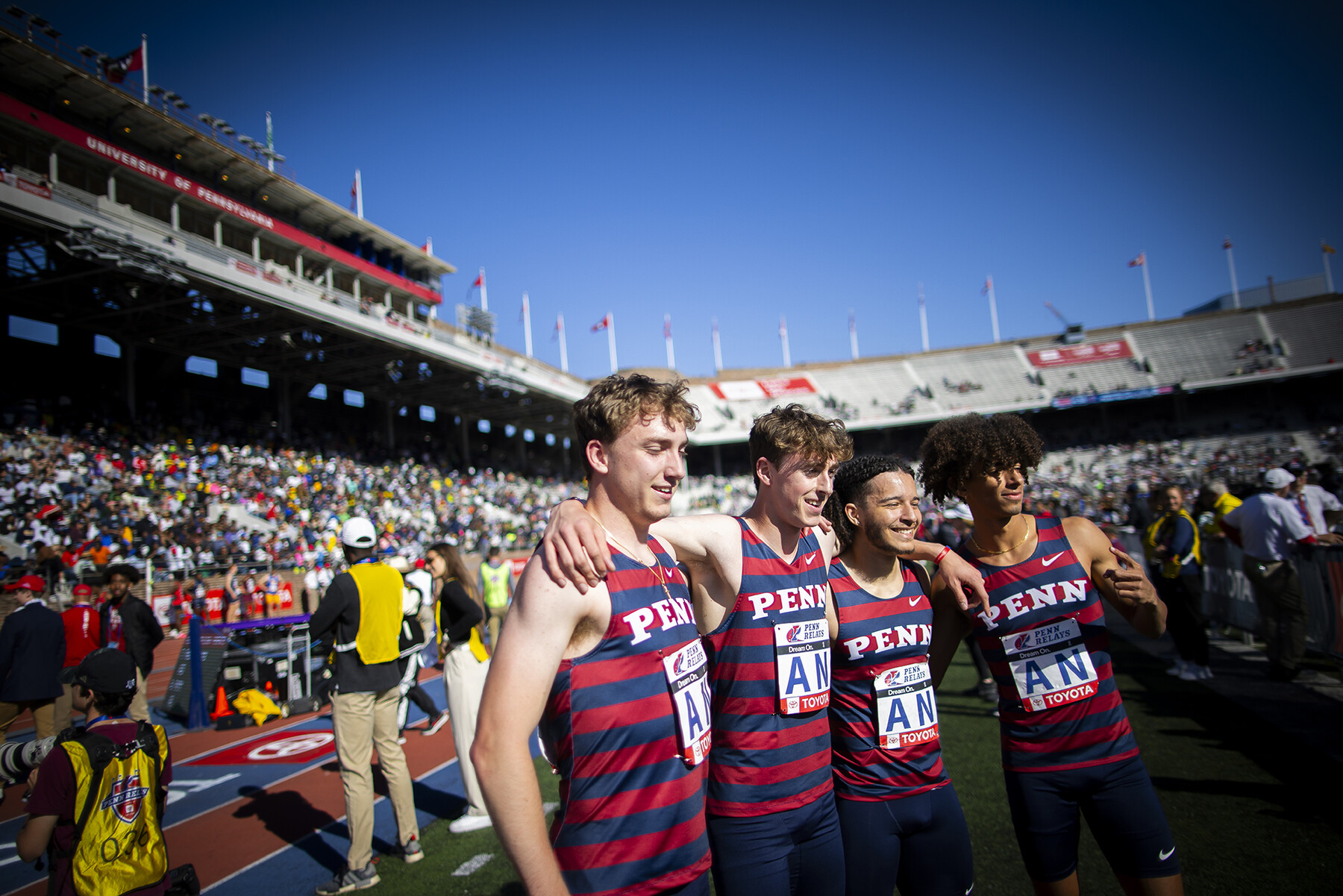 men's team celebrates after a penn relays race