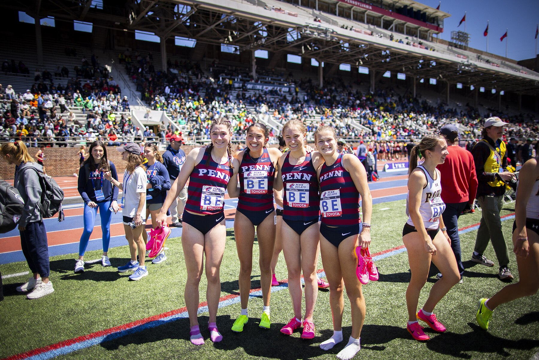 women's team celebrates after a penn relays race