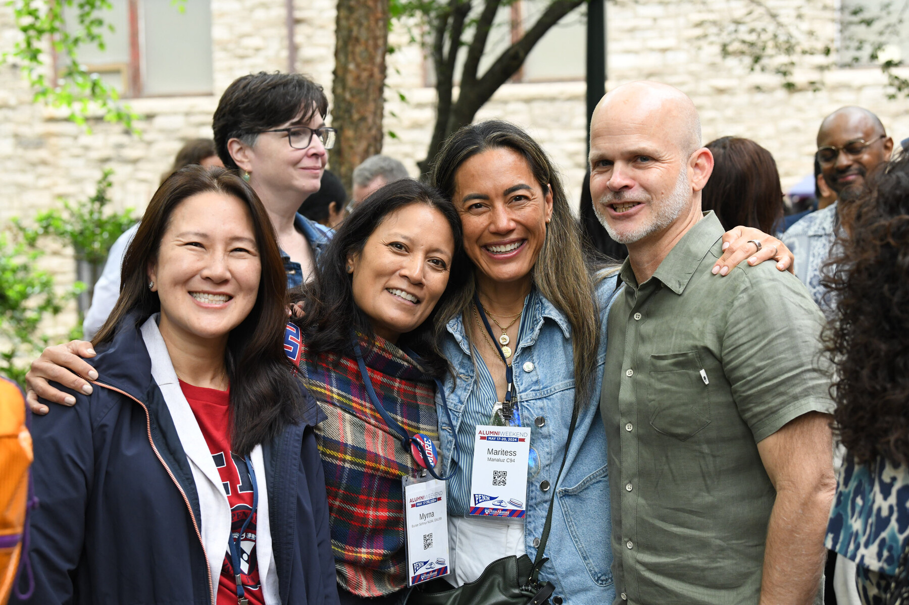 four people pose for a photo