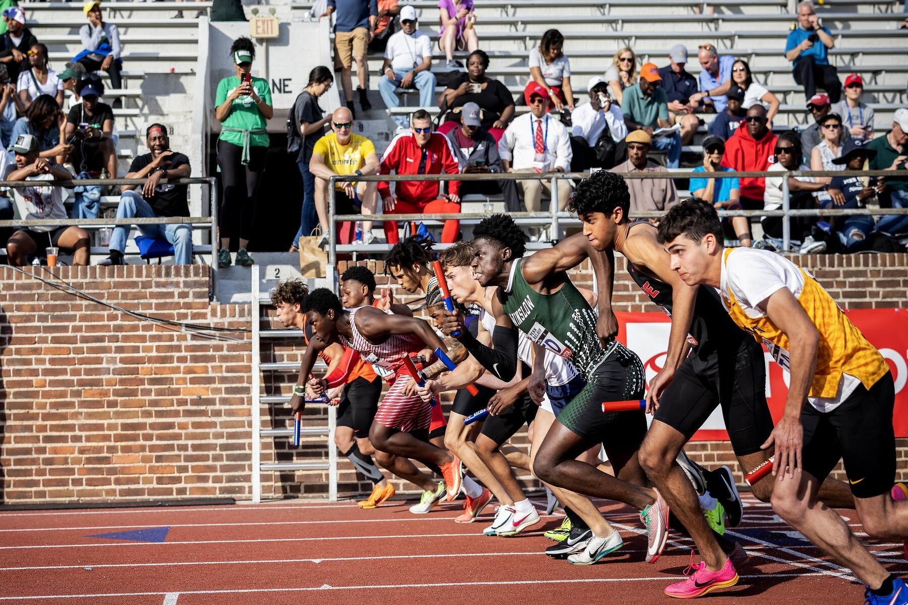Runners lined up at the start of a track race.