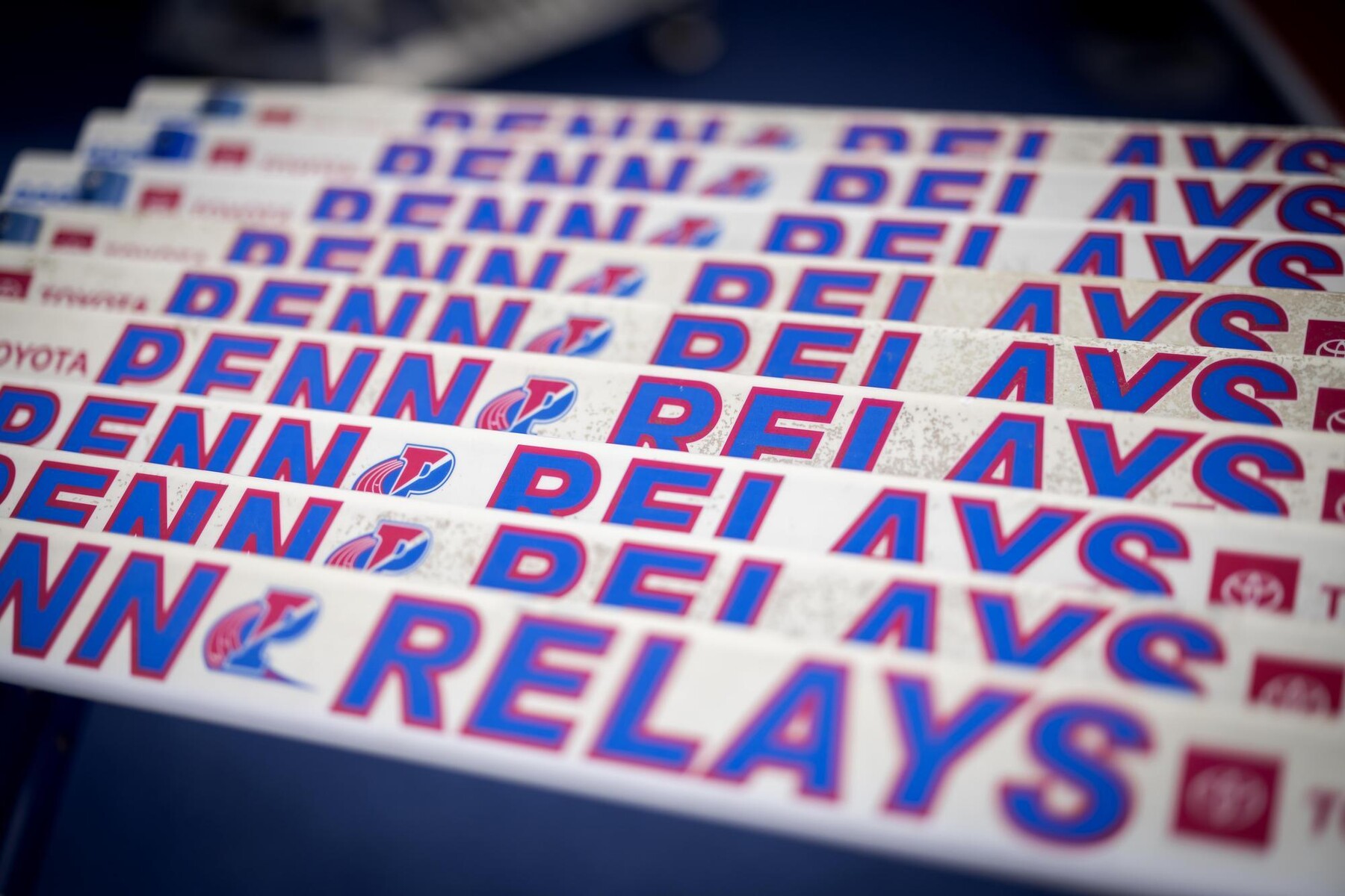 Several Penn Relays stickers stacked on a table.