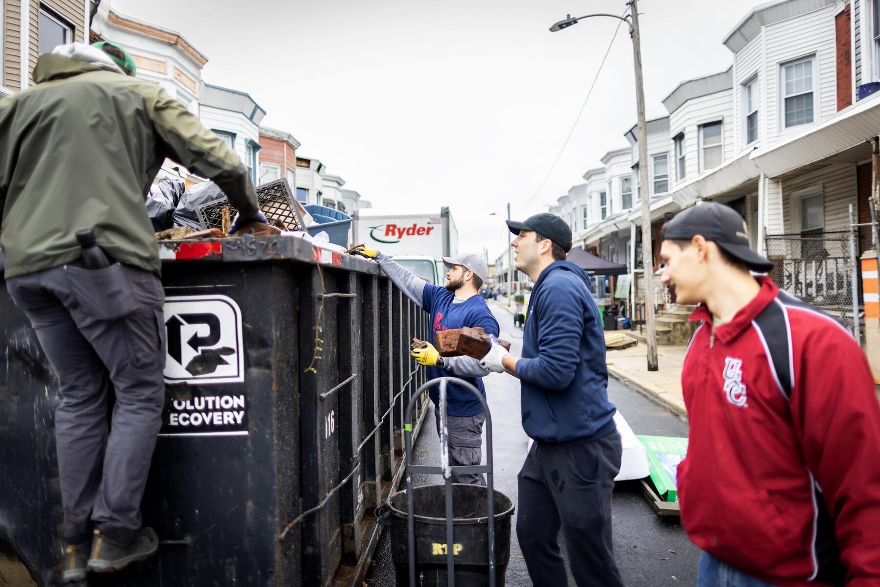 Volunteers lifting excess waste into a loading vans during the block build.