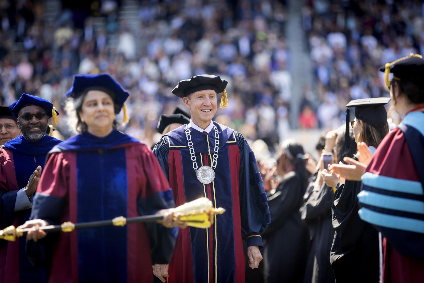 J. Larry James and Medha Narvekar in procession at Penn’s Commencement ceremony at Franklin Field.