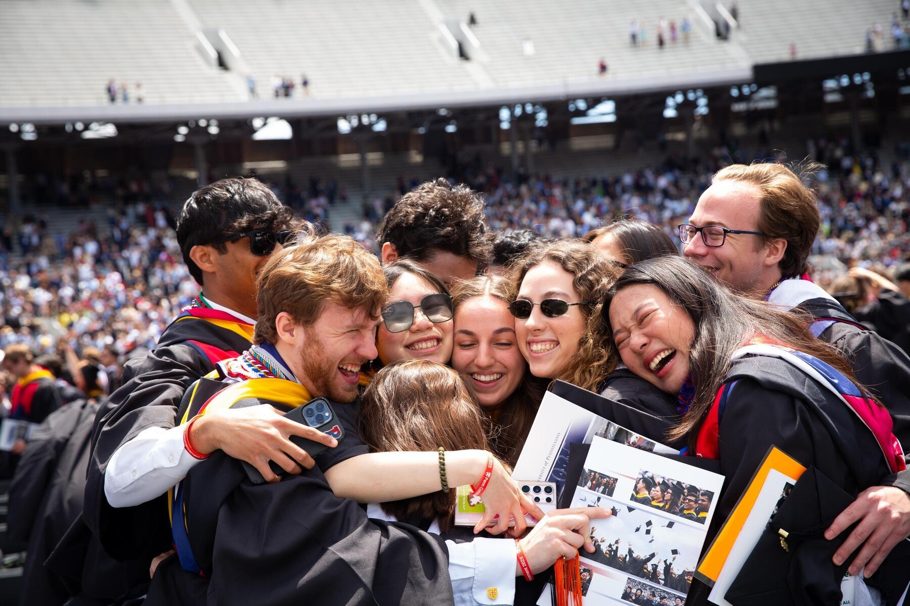 Graduates hugging at Penn’s 269th Commencement.