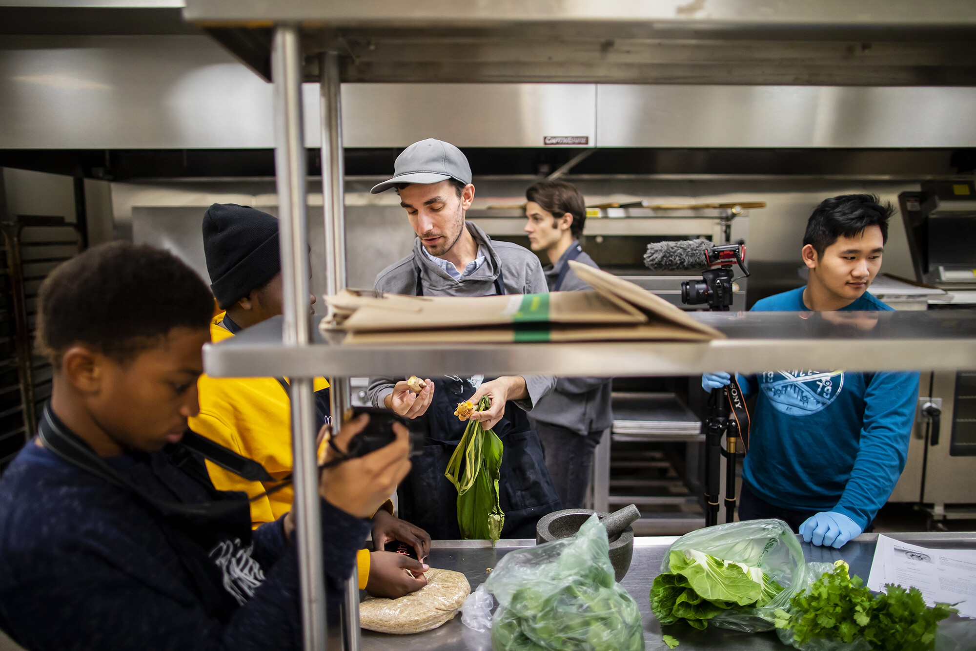 Jarrett Stein in the kitchen talking about a food product with a worker