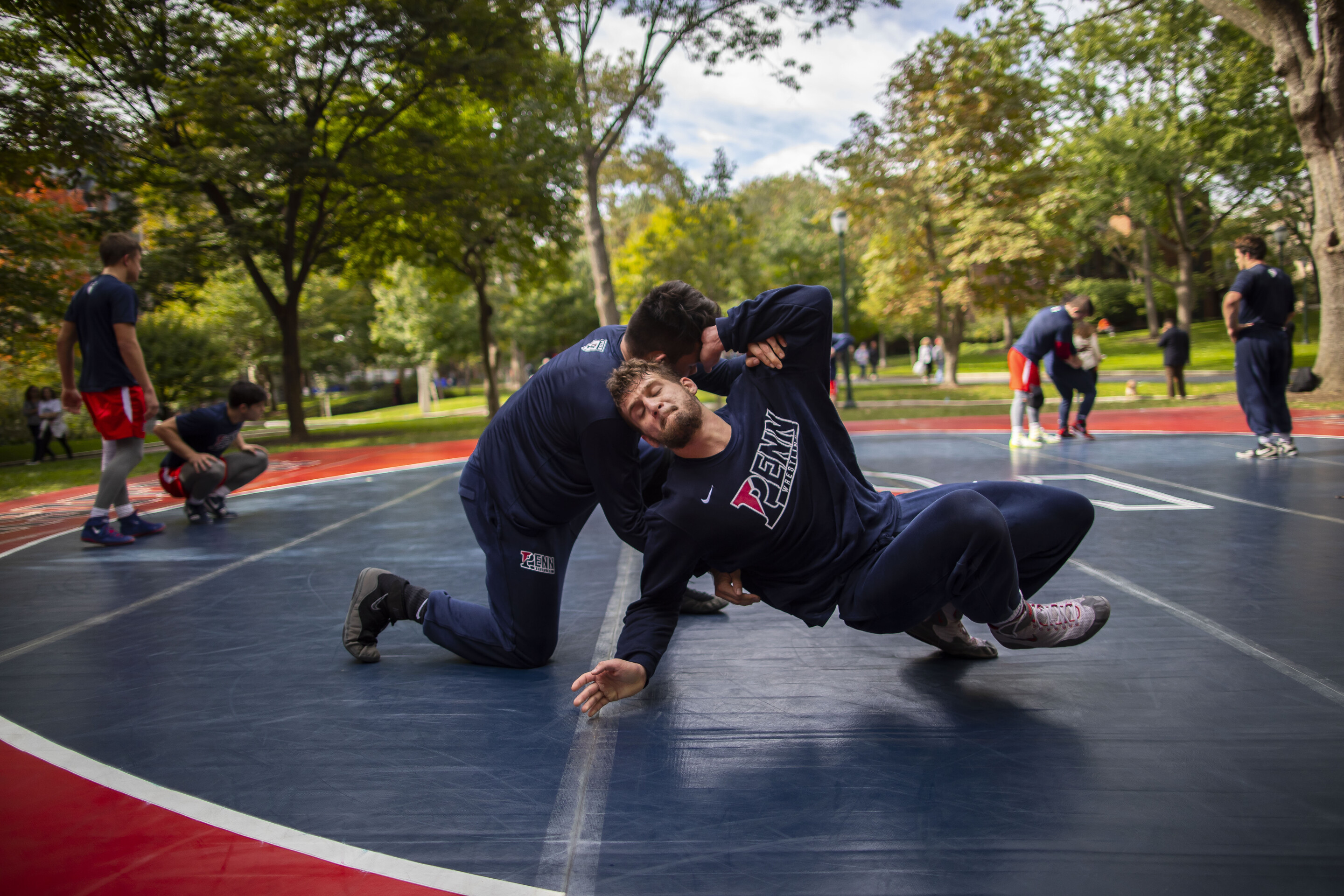 wrestling-team-members-practicing-outdoors-hitting-the-ground